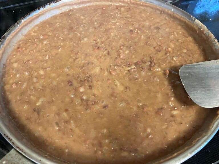 Homemade refried beans served in a bowl with authentic Mexican flavor.