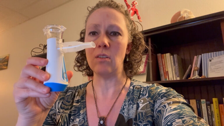 Woman holds portable nebulizer device